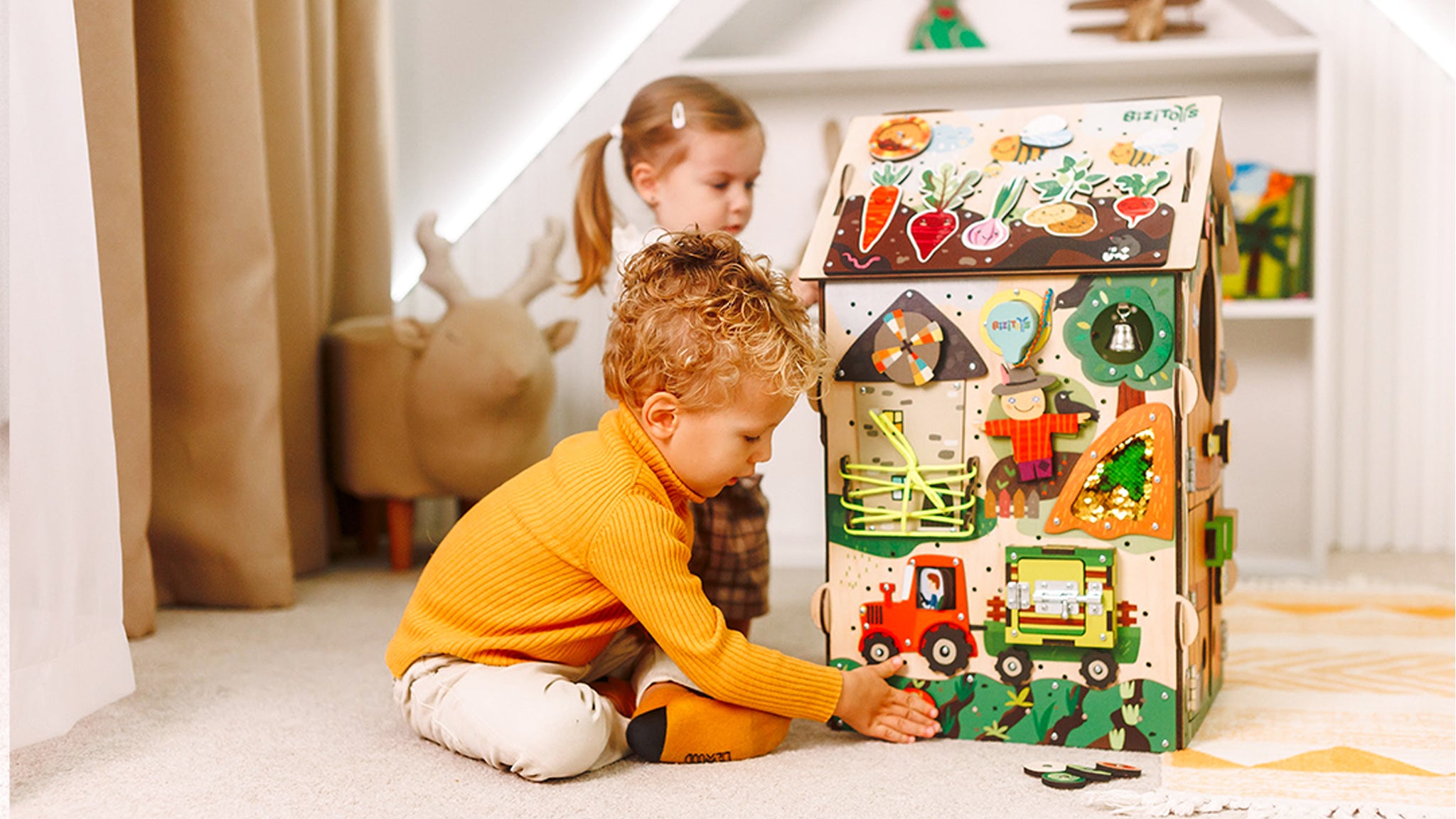Two children playing with a wooden toy block set in a room.